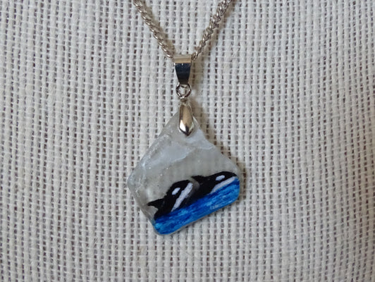 Painted orcas on sea glass pendant