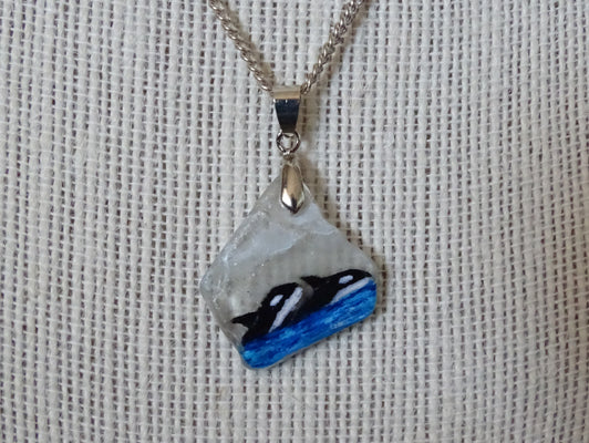Painted orcas on sea glass pendant