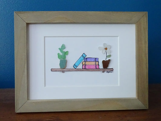 Sea glass bookshelf with plants artwork