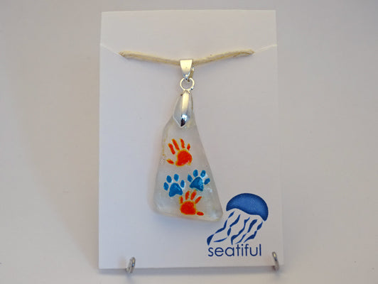 Paw and hand prints painted on sea glass pendant