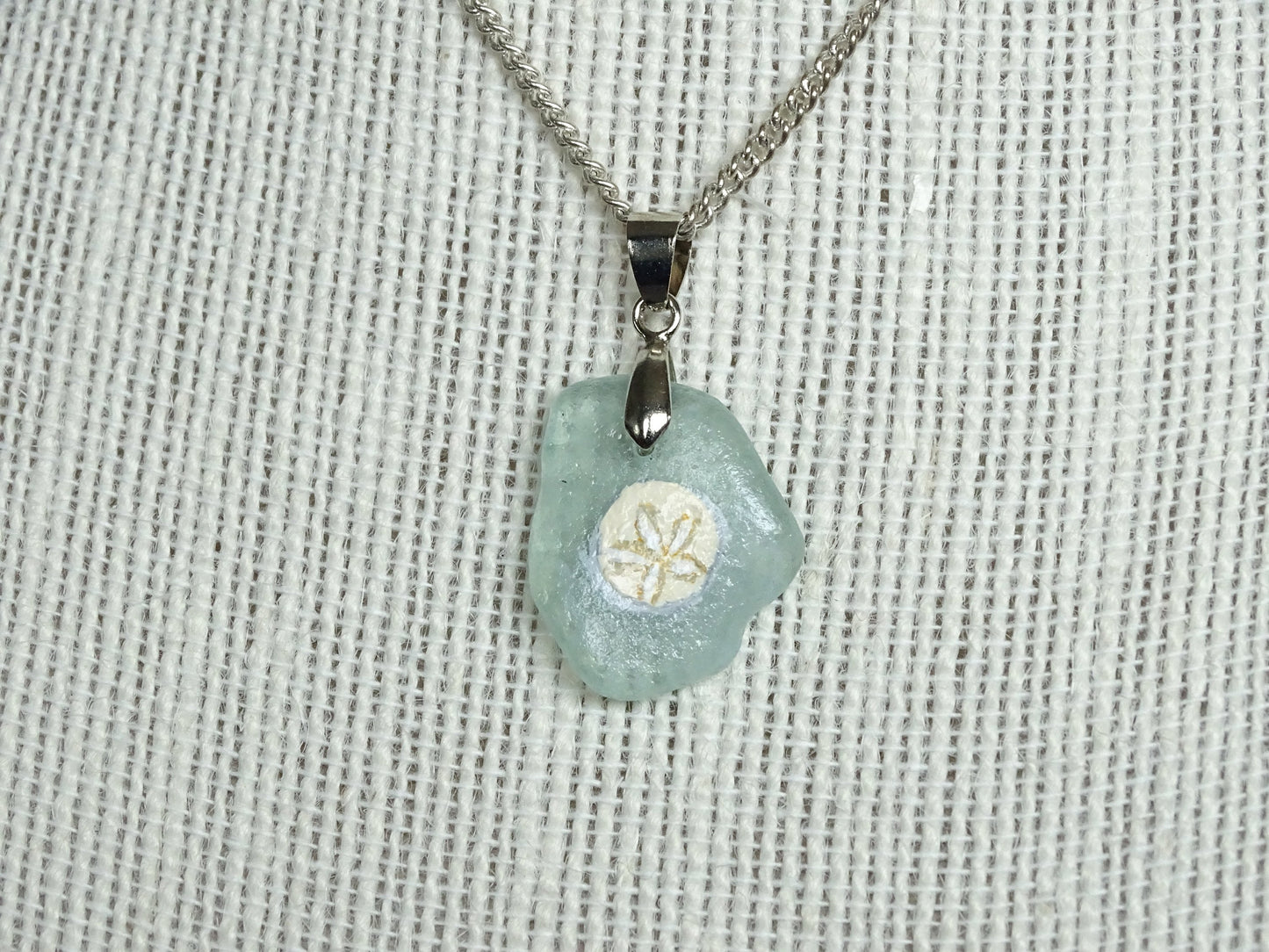 Sand dollar painted on green sea glass pendant